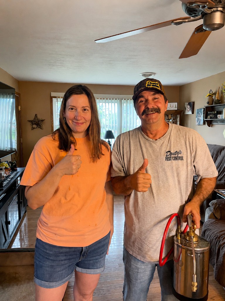 A Douty's technician and a customer giving thumbs-up inside a North-Central PA home