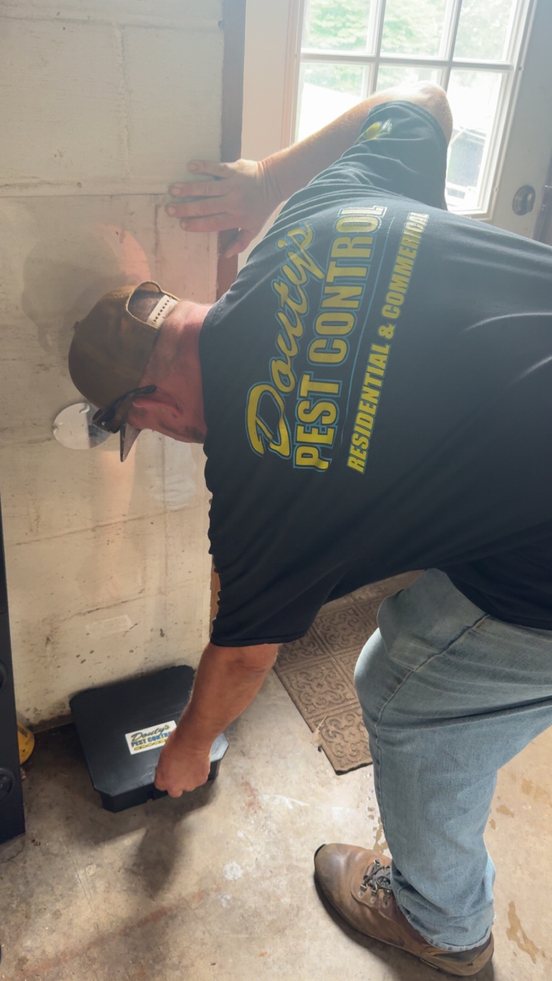 A Douty's Pest Control technician inspecting a cellar foundation in Muncy, PA