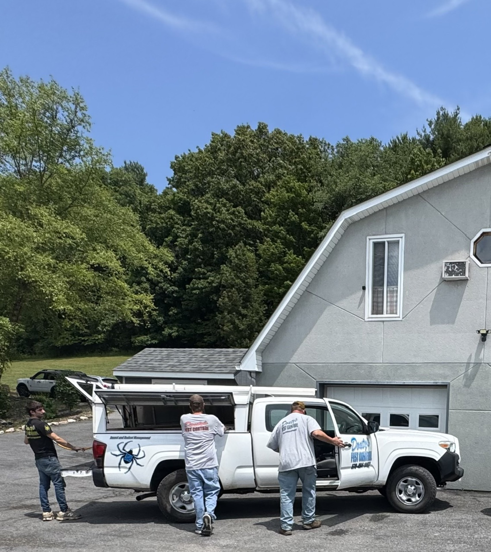 Douty's Pest Control technicians loading a service truck for pest control in Muncy, PA