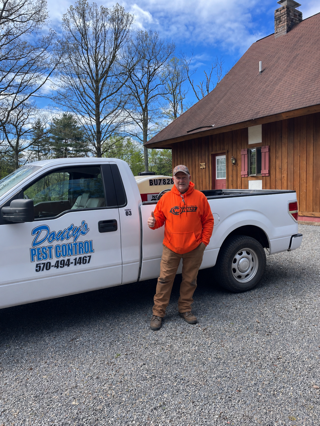 Douty's Pest Control truck at a Williamsport, PA home after flea treatment