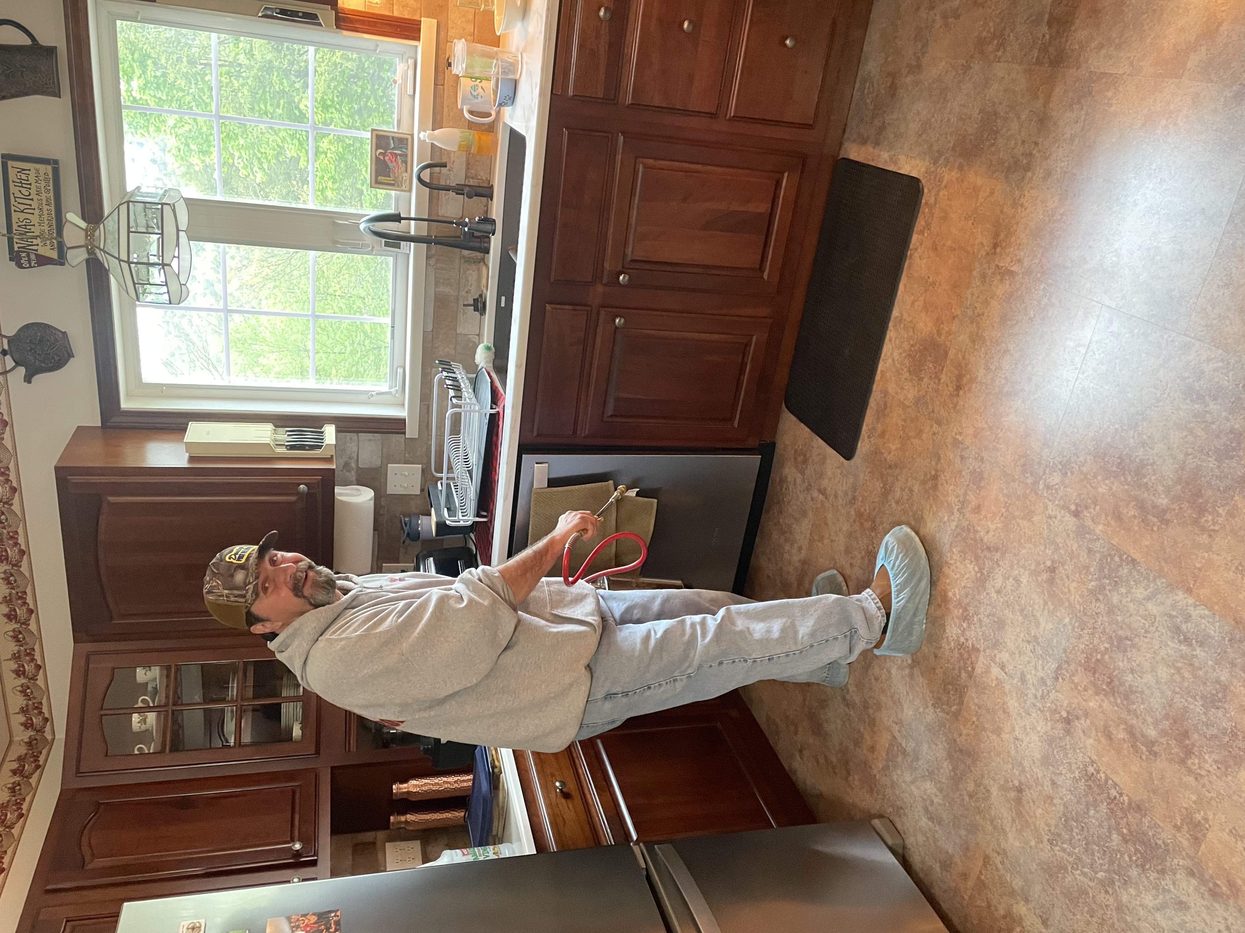 Douty's technician treating baseboards for bed bugs in a Williamsport, PA home
