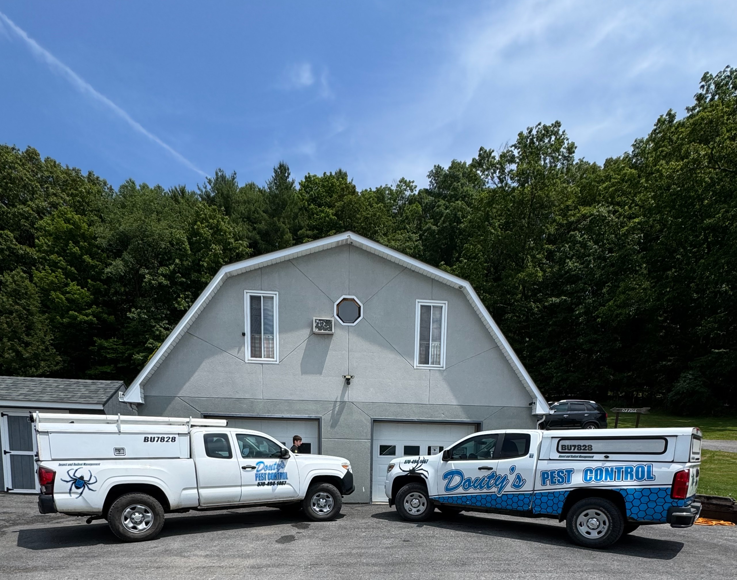 Douty's Pest Control trucks outside a Williamsport-area commercial building